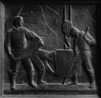 man and woman sitting on bench statue