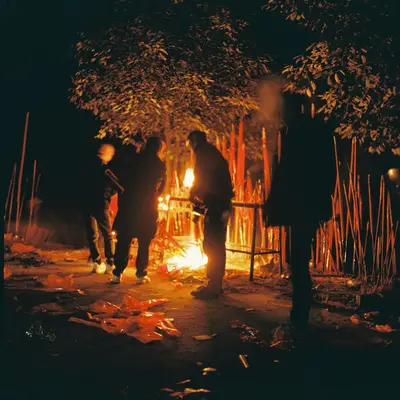 People gathered around a bonfire at night