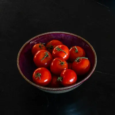 red cherry fruits on red ceramic bowl