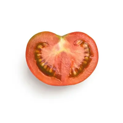 a tomato cut in half on a white background