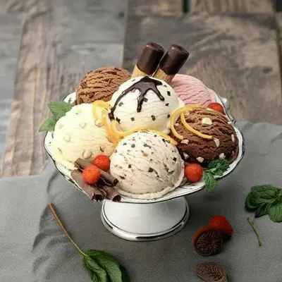 a bowl of ice cream and cookies on a table
