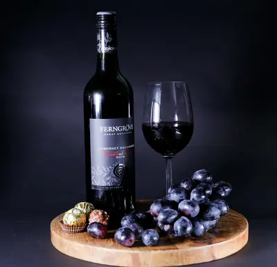 a bottle of wine next to a glass of wine